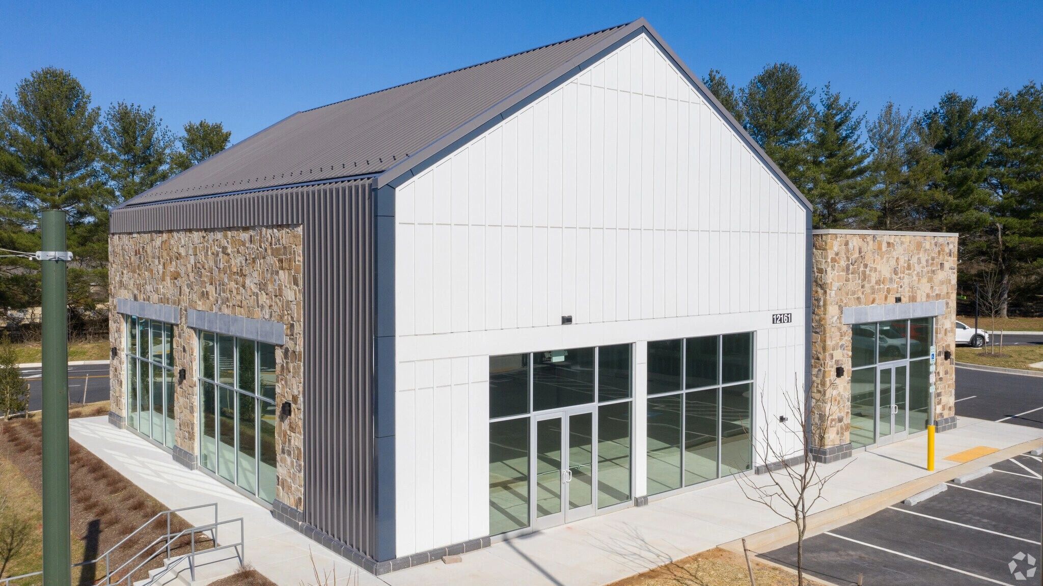 The Dance Athletics Studio building exterior at 12161 Clarksville Pike — modern barn-style architecture with stone and white siding.